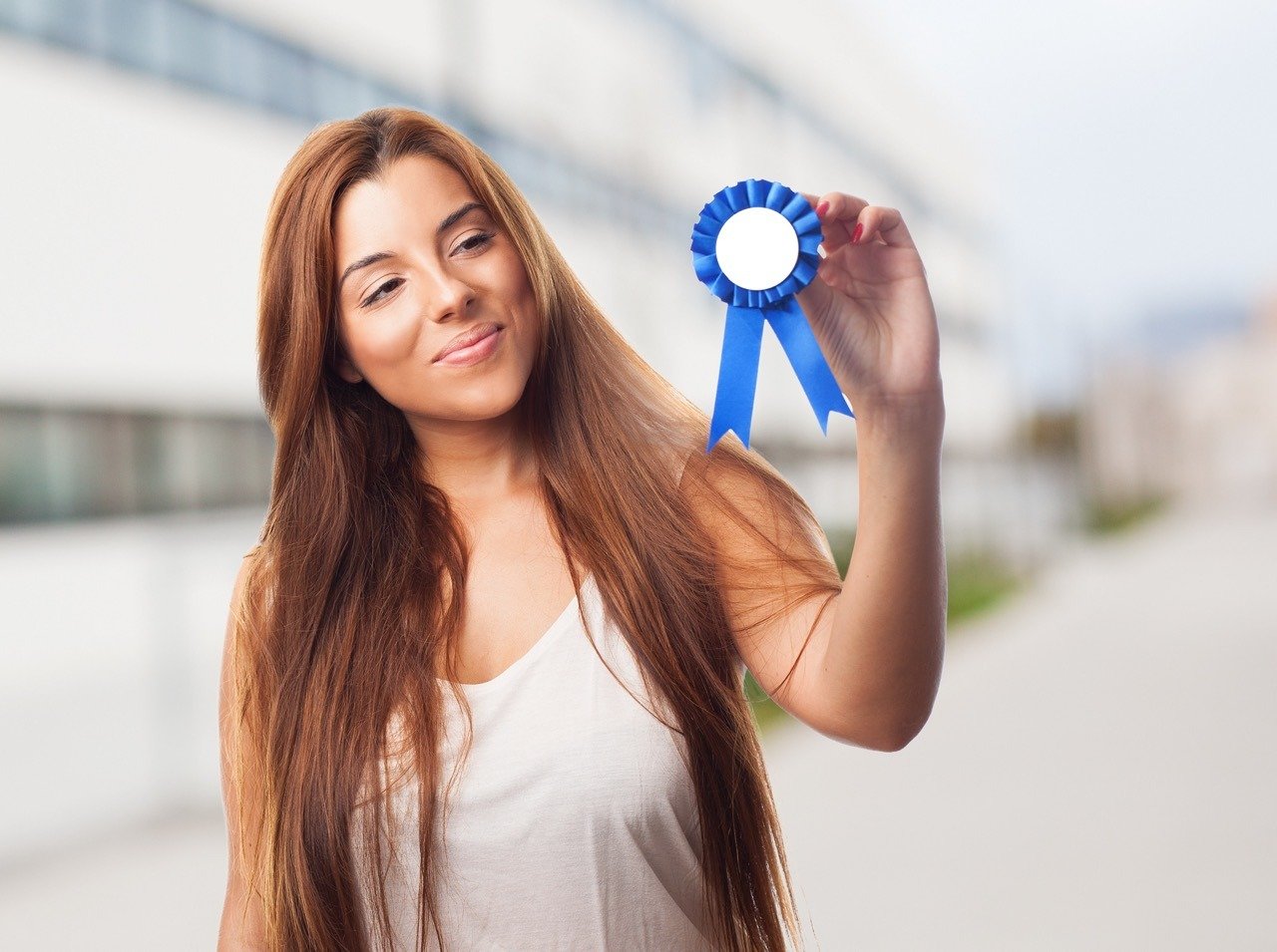 portrait of a young woman holding a badge