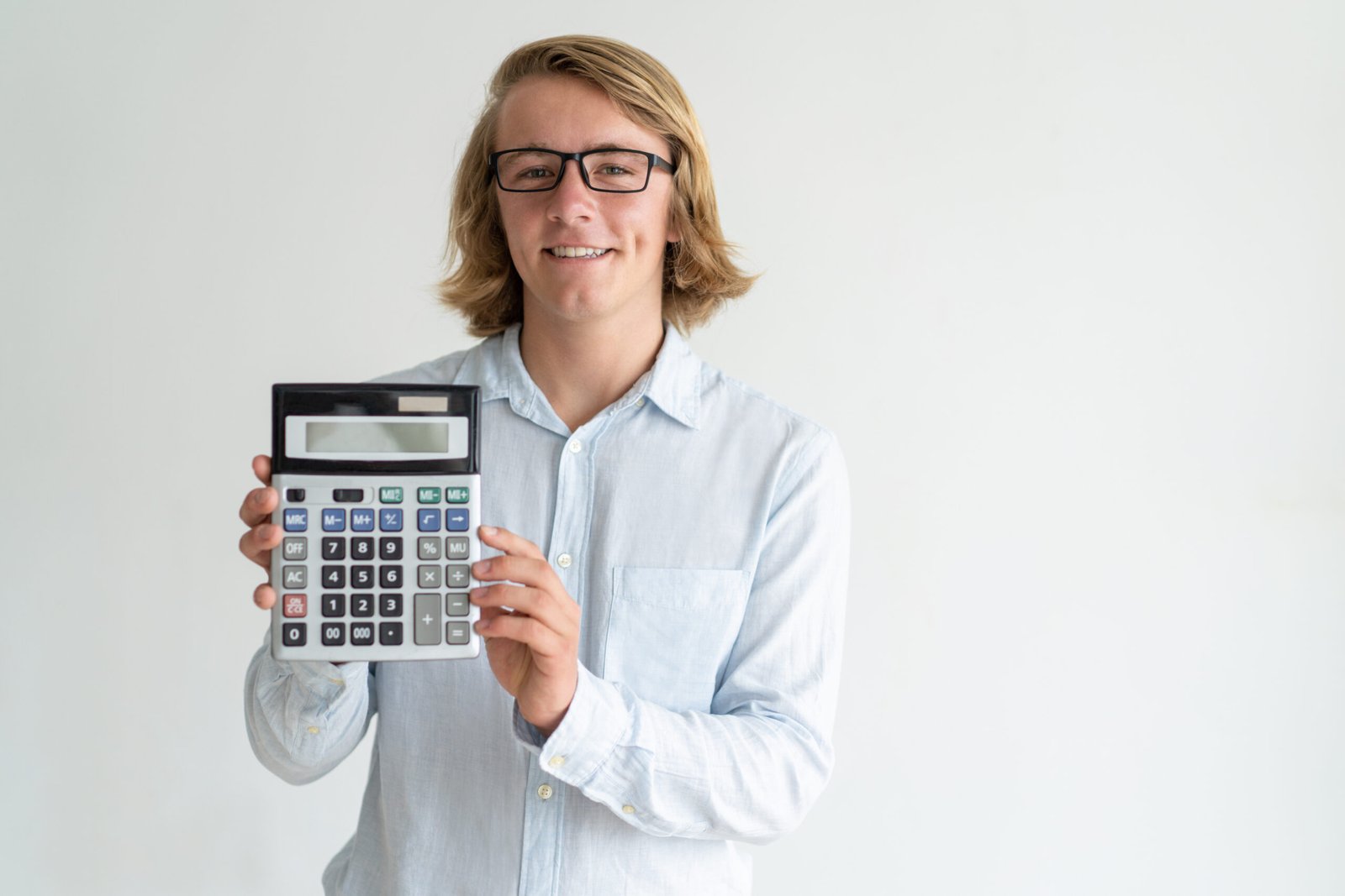 Smiling banker illustrating benefit of bank products. Happy Caucasian man in glasses showing empty calculator screen at camera. Finance and accounting concept